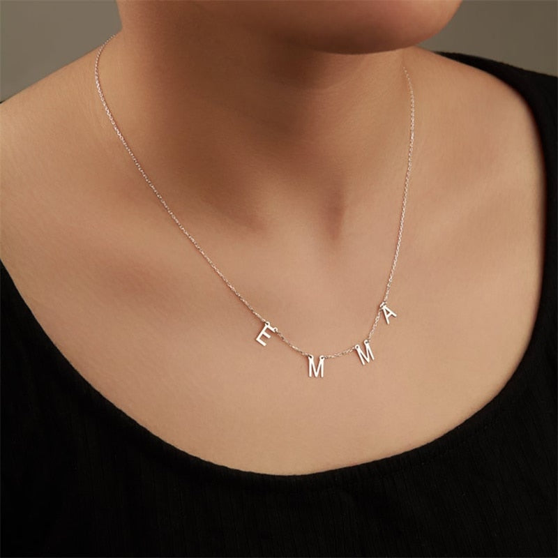 Charm Letter Name Necklace in Silver on model's neck