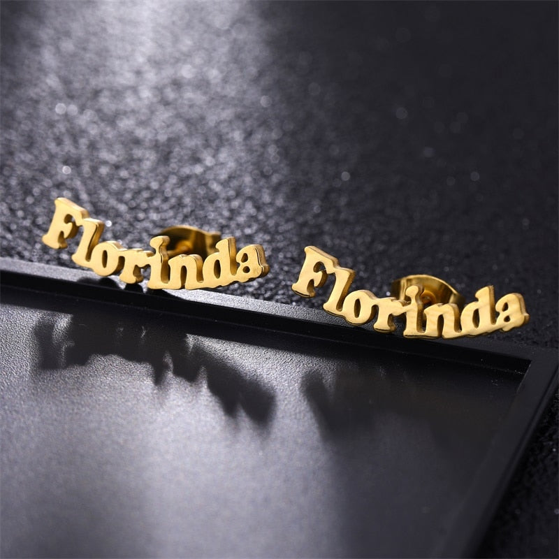 Nameplate Stud Earrings on black background