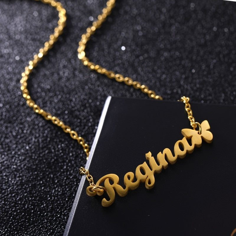 Nameplate necklace with butterfly accent up-close view