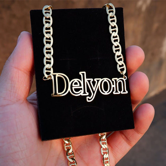Metro Outline Name Necklace on black background in model's hand