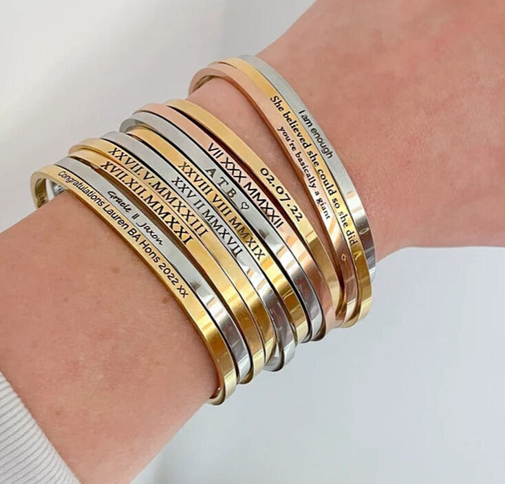 Cuff Bracelets stacked in gold, silver and rose gold on model's wrist